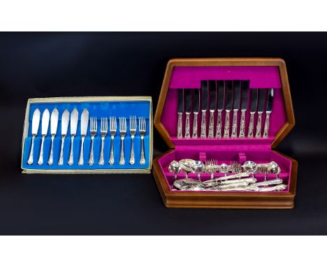 Two Boxed Canteens Of Cutlery The first a large collection of ornate flatware housed in hinged wooden fitted case. Secondly, 