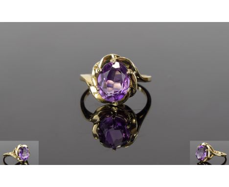 Amethyst Solitaire Ring set in 9ct gold; an oval cut of 2.5cts with a stepped frame above a slightly elevated gallery, the sh