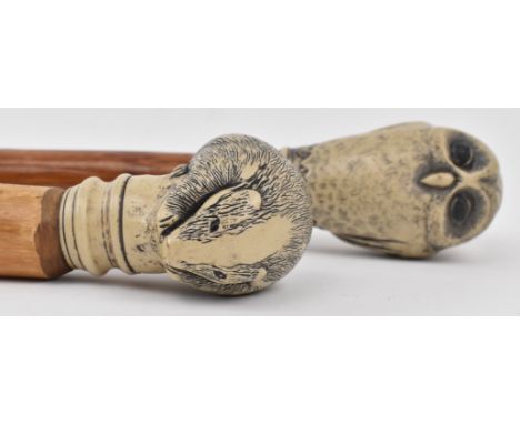 Two vintage 20th century Japanese walking sticks, each featuring resin carved handle in the form of an animal. Comprising a s