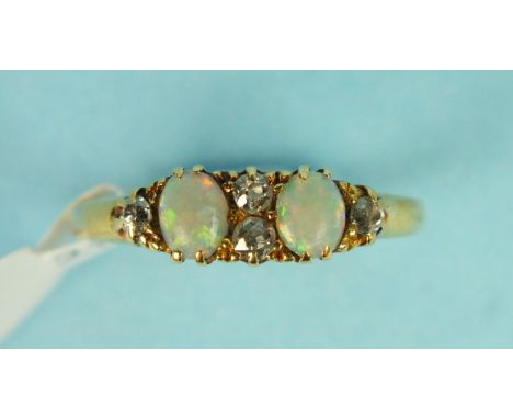 An opal and diamond ring set two opals and four old brilliant cut diamonds in unmarked gold mount, size M 1/2, 2.9g.