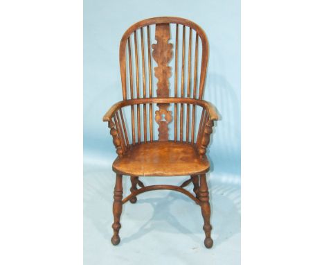 A 19th century elm and beech Windsor chair with stick back and solid seat, on turned legs with crinoline stretcher.