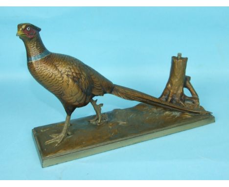 A cold-painted spelter figure of a cock pheasant on an oblong base, with tree trunk match strike, 31cm.
