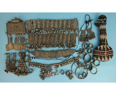 A collection of Omani silver jewellery including two anklets, six tassels, a necklace, a bracelet, a Hirz and a beaded kohl f