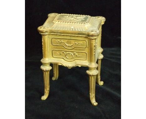 A late-19th/early-20th century French gilt metal jewellery casket in the form of a miniature two-drawer commode, with lift li