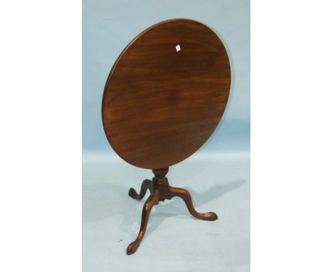 An Antique mahogany circular tilt-top table on turned column and tripod, 73cm diameter.