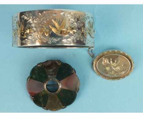 A Victorian style silver hinged bangle, Chester 1953, a Scottish hardstone brooch and a Victorian silver locket back brooch, 
