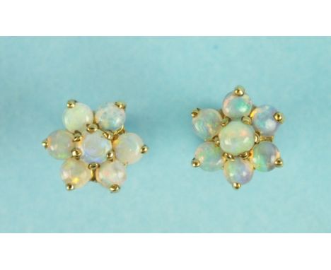 A pair of opal cluster earrings on gold mounts.