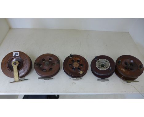 Five vintage wooden fishing reels ranging in size from 15cm diameter to 14cm diameter