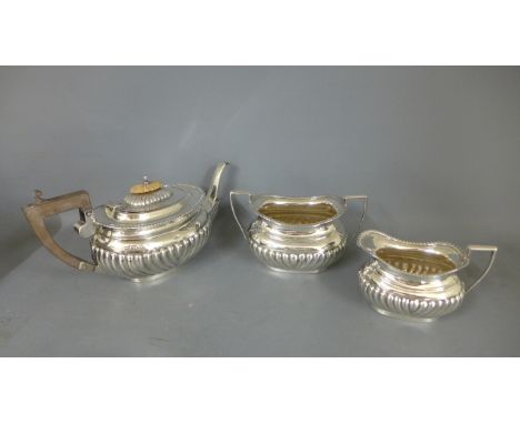 A silver bachelors three piece tea set - teapot and bowl Birmingham 1911/12 - jug Chester 1911/12 - total weight approx 13.5 