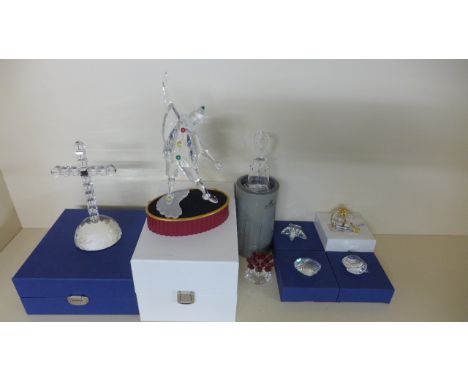 A Swarovski Crystal Masquerade Pierpot annual edition 1999, a Swarovski crucifix on semi circular base, a Swarovski Crystal S