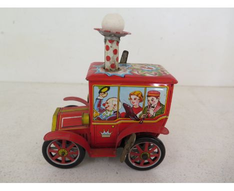 A Japanese K.O. Toy Company tin plate clockwork circus car with chimney 1950/60 clockwork action working well and lithograph 