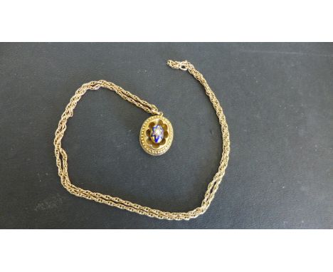 A yellow metal and enamel mourning brooch on a 9ct yellow gold chain - Length 60cm - total weight approx 12 grams
