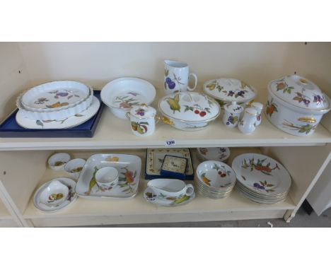 A Royal Worcester Evesham dinner service to include three tureens, dishes, plates and cruet - 38 pieces and place mats - some