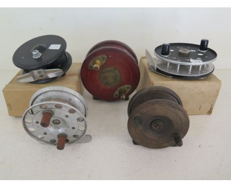 A collection of five vintage centre pin reels to include a Slater latch reel, an 1860/80 iron back reel and a scarce TH Markw