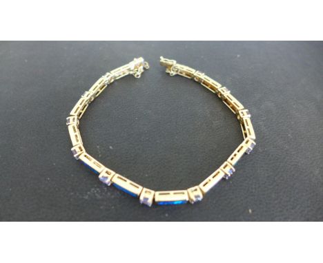 A black opal and tanzanite 14ct yellow gold bracelet - approx weight 12.7 grams - Length 18cm - safety chain broken