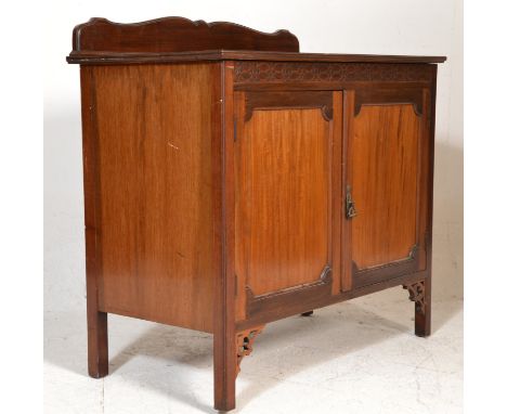 An Edwardian mahogany shoe cupboard. Raised on squared legs with pad feet having twin doors with shelves set inside. The fiel