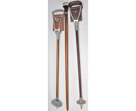 A 20th Century walking stick cane having a tapering wooden shaft with a bulbous cast resin knob to the top having a silver to