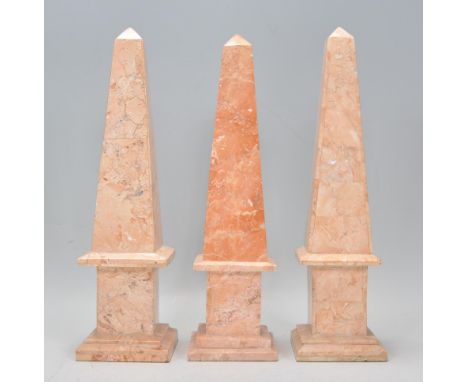 A group of three antique neoclassical carved pink marble obelisk mantelpiece ornaments, each bing raised on square plinth bas