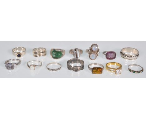 A group of 14 silver rings to include an amber set ring, a hallmarked band ring set with a round cut purple stone, a dress ri