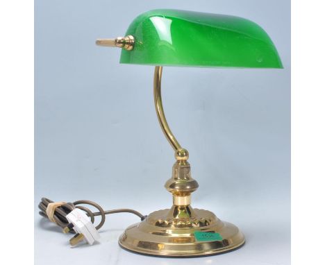 A 20th century bankers lamp having a brass body with a curved neck and rotating green glass shade.&nbsp;