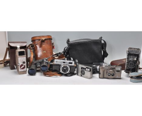 A mixed collection of vintage 20th cameras and film cameras to include a leather cased Bell &amp; Howell 624 8mm camera, Fuji