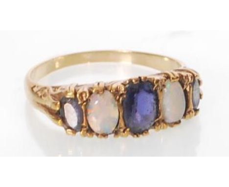 A hallmarked 9ct gold sapphire and opal gypsy ring. Hallmarked Birmingham. Weight 2.9g. Size R.&nbsp;