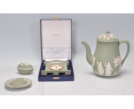 A group of 20th Century Green Wedgwood jasperware ceramic items to include a teapot, ashtray, boxed clock and a small egg sha