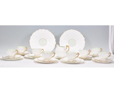 A vintage 1920s Art Deco eight person tea service to include tea cups, saucers, milk jug, side plates and two large plates, e