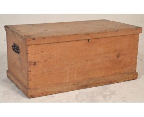 A Victorian 19th century country pine blanket box chest of rectangular form with hinged top over plain panel sides and carry 