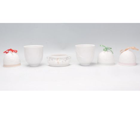 A collection of Lladro to include three porcelain bells with embossed decoration, a small twin handled classical style trinke
