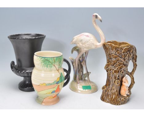 A collection of vintage Art Deco ceramics to include a Sylvac tree stump planter, tree trunk and squirrel vase, a Clarice Cli