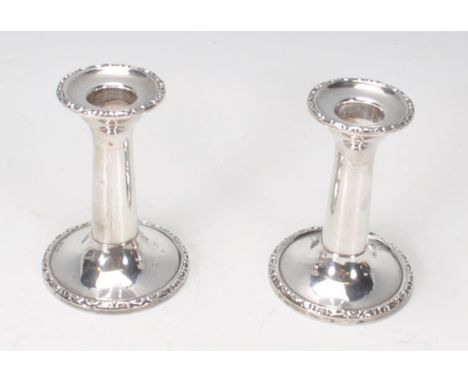 A pair of 1919 Chester hallmarked silver stub candlesticks by J &amp; R Griffin. Each with single sconces and gadrooned edges