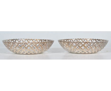 A matching pair of early 20th Century silver hallmarked trinket / pin dishes having pierced decoration. Hallmarked for Birmin