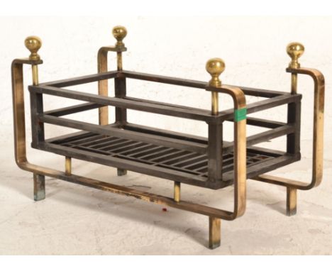 A good 19th Century Victorian iron and brass fire grate. The round brass frame with brass ball finials supporting the iron gr