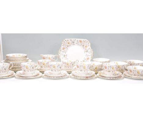 A vintage 20th century Foley China porcelain tea service by Donald Brindley in a chintz pattern comprising cups, saucers, pla