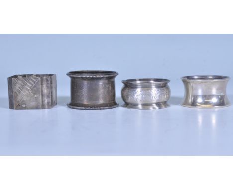 A harlequin set of silver napkin rings to include a ring having engraved ivy leaves, a napkin ring with engine turned decorat