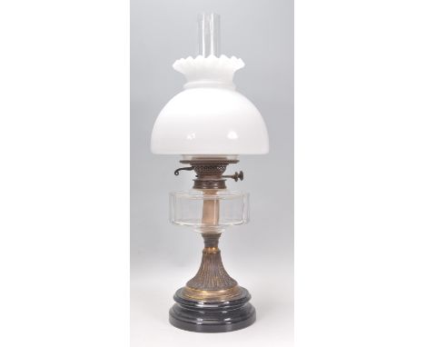 A 19th Century Victorian oil lamp raised on a round ebonised base with a reeded column, glass reservoir, white glass shade an