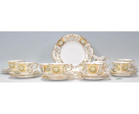 A Royal Crown Derby tea service in the Green Derby Panel pattern with floral decoration and gilt detailing. The service compr