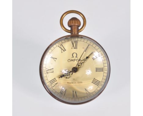 A vintage Omega style desktop glass orb clock having a white enamelled face with roman numerals to the chapter ring and pierc