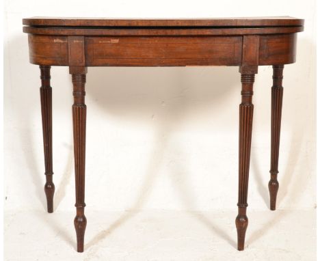 A George III&nbsp; 19th century mahogany tea / card games table being raised on reeded and tapering legs with fitted half moo