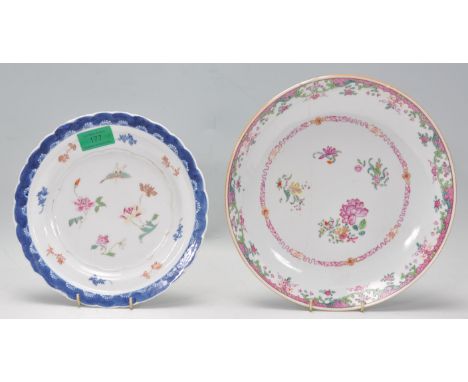 Two Chinese 19th Century polychrome porcelain plates to include a famille rose shallow bowl decorated with flowers and butter