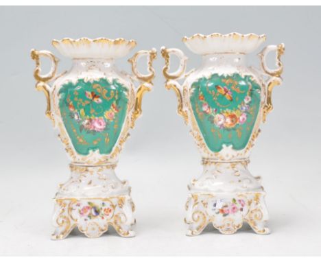 A pair of 19th Century Victorian porcelain mantelpiece garniture vases of tapering form having gilt scrolled handles with han