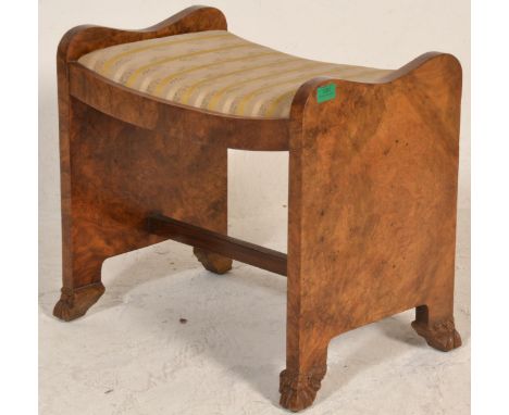 A mid century Queen Anne walnut dressing table stool. Raised on shaped legs with shell feet having a shaped fitted frieze wit