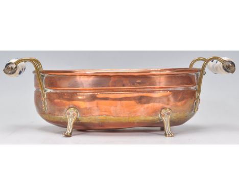A good 19th Century Victorian copper planter of oval form having blue and white ceramic handles united by brass supports. Rai