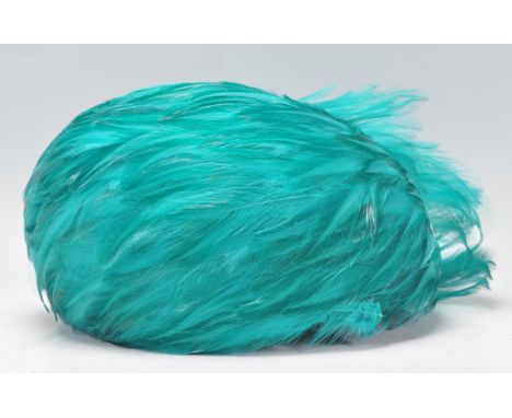 A vintage 1920's / 1930's Art Deco ladies hat having fine turquoise feathers in a spiral formation.&nbsp;
