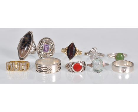 A selection of silver ladies dress rings to include an Art Deco style panel ring set with marcasites and a purple stone, a ce