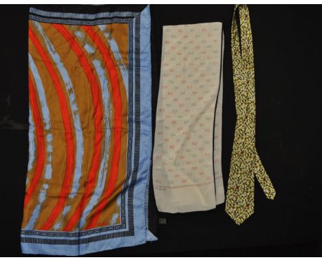 A vintage Versace silk neck scarf having a blue ground with a red and brown pattern and greek key borders together with a Chr