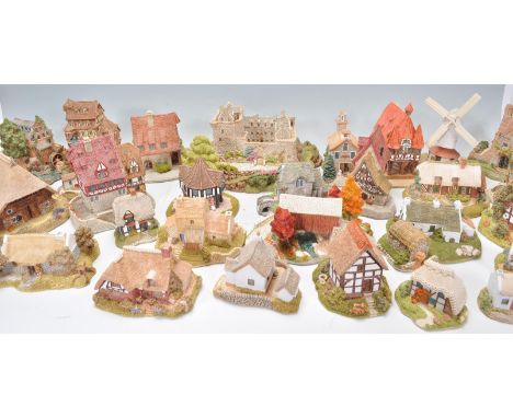 A large collection of various Lilliput Lane cottages to include Flower Sellers, Downegal Cottage, Strawberry Cottage, St Colu
