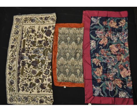 A group of three vintage Liberty printed silk scarves to include a blue floral print scarf, a peacock feather print scarf and