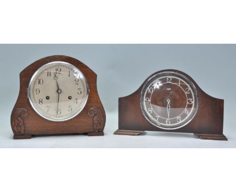 Two early 20th Century mantel clocks. One of oak domed construction having Arabic numeral chapter ring with applied carved mo